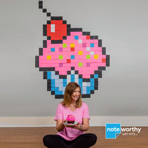 Post it note mural of large pink pixel art cupcake