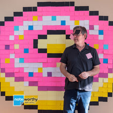 Load image into Gallery viewer, man standing in front of large postit note pixel art mural