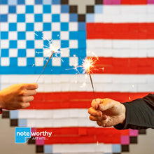 Load image into Gallery viewer, people holding sparklers in front of post it note pixel art USA flag wall mural